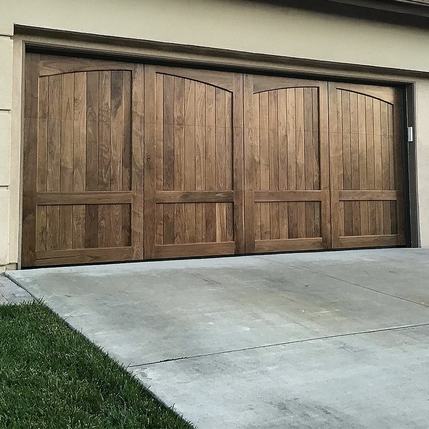 Custom wood carriage-style double garage door installed by CBJ in Central Texas