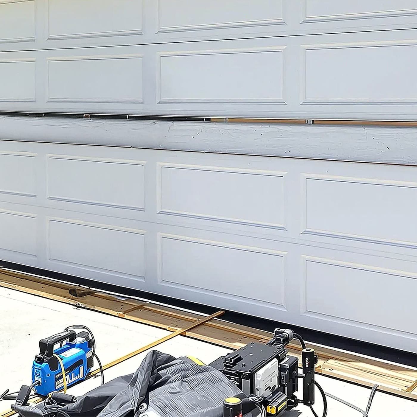 Residential garage door sections and hardware during a CBJ repair
